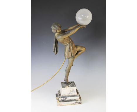 An Art Deco patinated spelter table lamp, early 20th century, modelled as an athletic lady with one leg raised, her hands rai