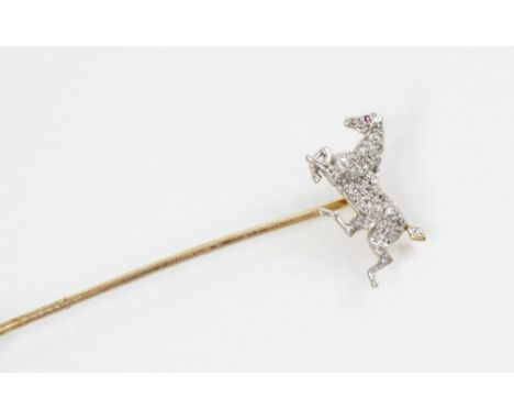An early 20th century diamond and ruby horse stick pin, the horse modelled in gallop and set with old cut diamonds and a mixe