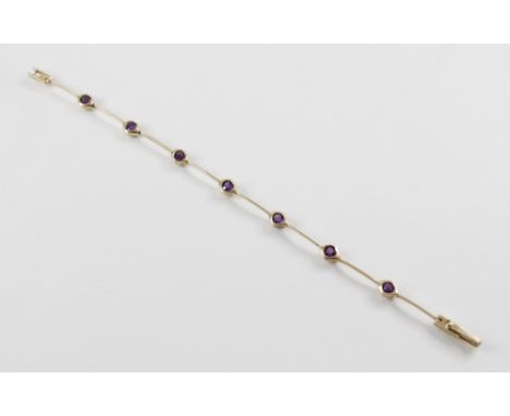 An amethyst set 14ct gold line bracelet, the articulated knife-edge bar link bracelet interspersed by seven diamond shaped pa