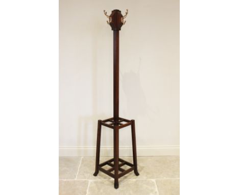 An early 20th century Arts and Crafts mahogany freestanding coat/hat stand, the four brass hooks mounted upon angular blocks 