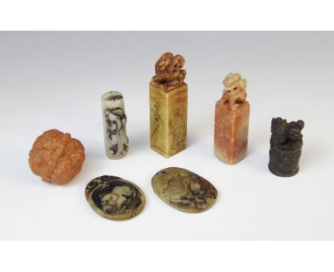 Three Chinese Jade carvings, comprising; two pendants, decorated with a crane and a dog of fo, each 5cm long, and a terminal 