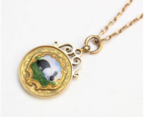 A 9ct yellow gold and enamel Dutch rabbit pendant, the circular pendant fob with central panel depicting a black and white ra