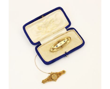 A Victorian 15ct gold diamond set Etruscan bar brooch, Chester 1895, the central round old cut diamond gypsy set to a raised 