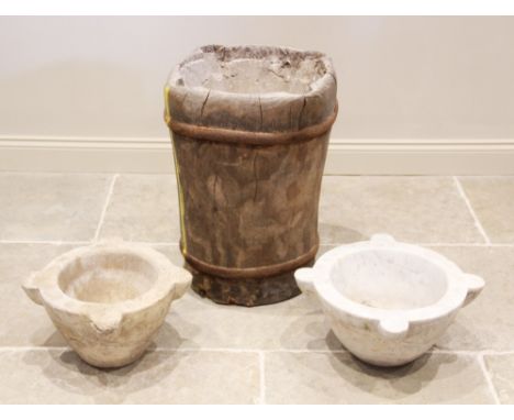 A 19th century iron ring bound mortar trunk pedestal, of cylindrical form, the top with a bowl recess and four projecting lug