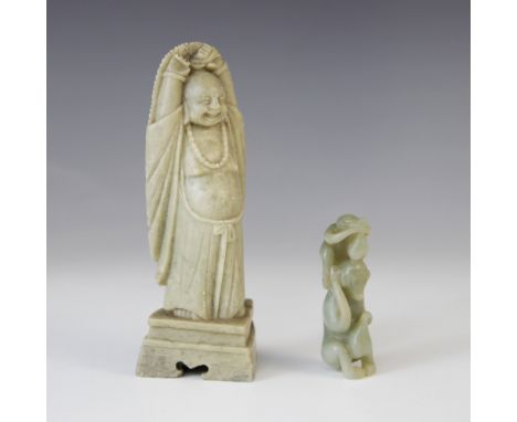 A Chinese jade carving, 20th century, depicting two monkeys and gourd fruits, 7cm high, with a Soapstone buddha, 15cm high (2