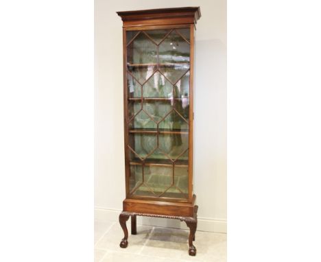 An early 20th century Chippendale revival mahogany display cabinet, with a Greek key pattern frieze over a single astragal gl