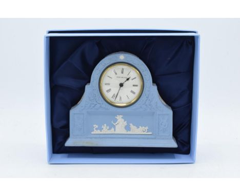 Boxed Wedgwood Jasperware in blue mantle clock with traditional moulded relief, 16cm wide.  In good condition with no obvious