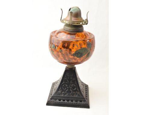 Edwardian oil lamp with ornate metal base and painted glass reservoir, 29cm tall.  Crack to the glass.