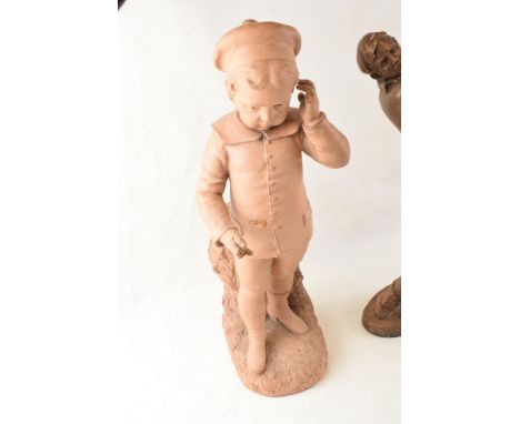 A pair of Art Deco style figures in the form of a golfer and a smart dressed boy, signed Secouner, tallest 49cm tall (damages