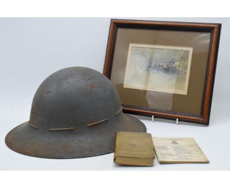 World War 2 British Zuckerman metal helmet 1941, together with Active Service Edition pocket bible, a 'Guide to HMS Vanguard'