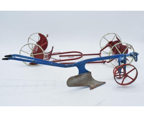 A trio of vintage 20th century metal farm machines to include a plough and 2 others, longest 38cm (3).  