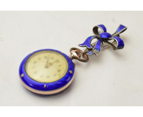 Silver and blue enamel ladies fob watch with inlaid silver decoration with bow pin, in working order, 65mm tall.  Some damage