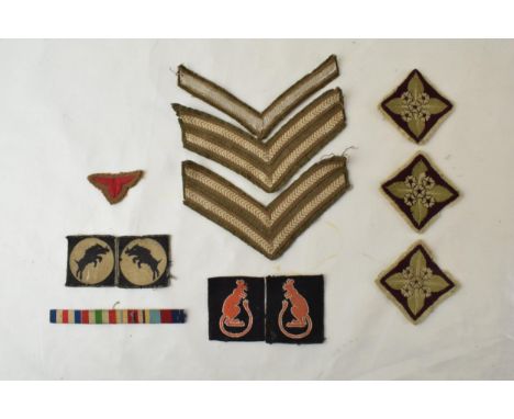 A good collections of WWII era military woven cloth badges to include a facing pair of 7th Army Desert Rats badges, a facing 