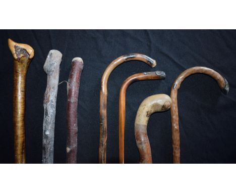 A collection of vintage wooden walking sticks of varying forms, longest 94cm tall, one with silver top (7).  Collection only.