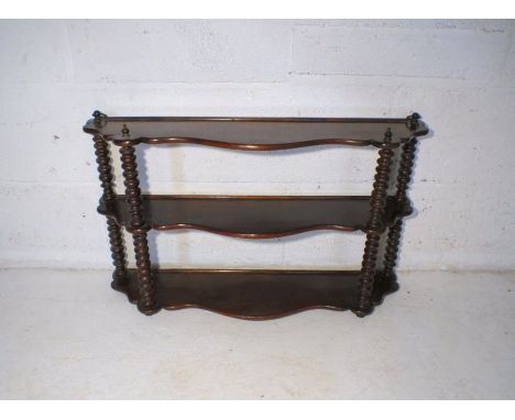 A Victorian mahogany wall hanging display shelf, with bobbin turned supports.
