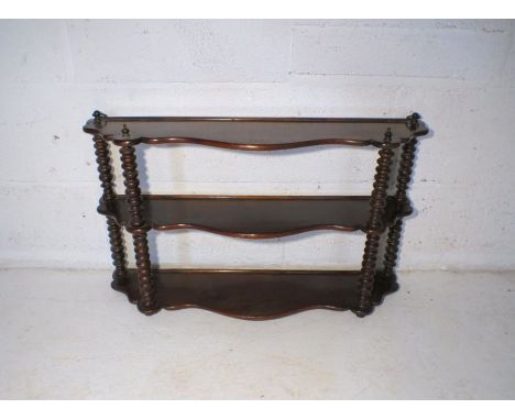 A Victorian mahogany wall hanging display shelf, with bobbin turned supports.