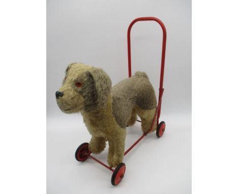 A child's Pedigree Soft Toys Ltd push-along dog