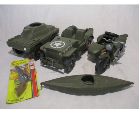 A collection of four Action Man vehicles including a tank, motorbike with sidecar, land rover and canoe, along with a Lone St