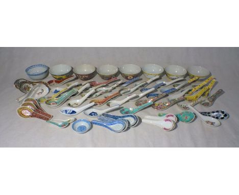 A collection of Oriental ceramic spoons and bowls, some with character marks.