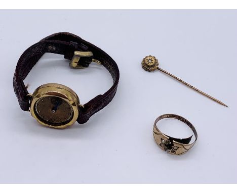 A 9ct gold stick pin set with a seed pearl, scrap 9ct ring and a ladies 9ct gold watch ( A/F)- weight of pin and ring 1.8g