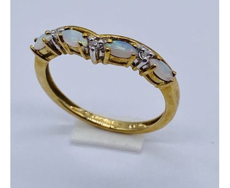 An opal and diamond half eternity ring set in 9ct gold