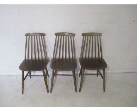 Three mid century Ercol style stick back chairs.