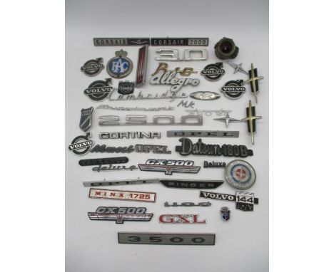 A collection of vintage car badges including Ford, Volvo, RAC, Allegro, Vauxhall, Cortina etc