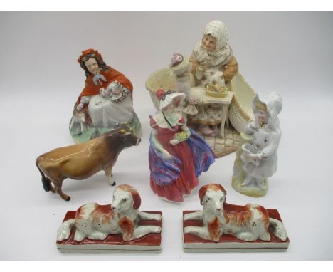 A small collection of various ceramic figurines including a Beswick Jersey "Dunsley Coy Boy", Royal Doulton "Lady April" etc