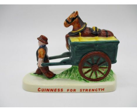 A vintage Carlton Ware ceramic Guinness figurine depicting a Drayman pulling a cart with a sleeping horse on top, marked with