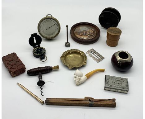 An assortment of items including Swiss made desk barometer, pot lid, engineer's compass, fishing reel etc.