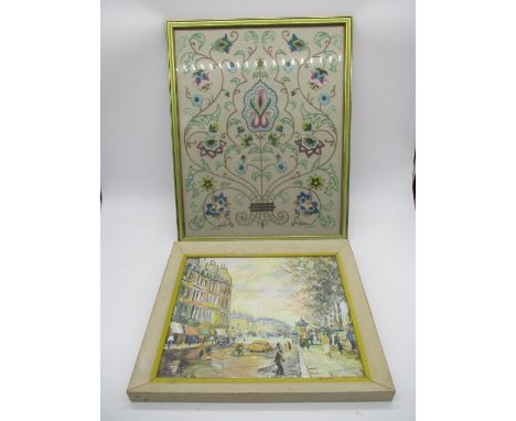 A framed print of a street scene by George Hann entitled "Quai St Michel", along with a framed embroidery 