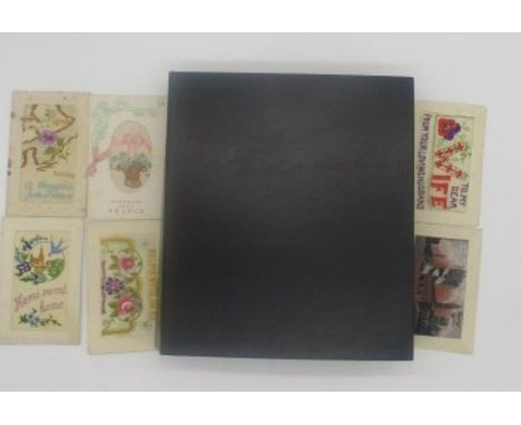 An album containing a collection of forty five first world war embroidered cards, album also contains a selection of first da