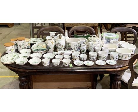 A large collection of Portmeirion including tureens, storage jars, ramakins, vases, clock, rolling pin, serving dishes etc. 