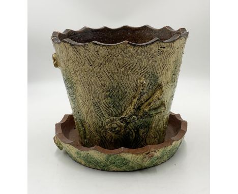 A studio pottery plant pot and tray in the form of a tree trunk 