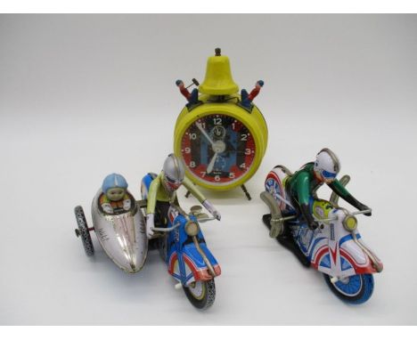 Two reproduction tinplate wind-up motorbikes, one with side car, along with a vintage German Jerger Busy Boy alarm clock with