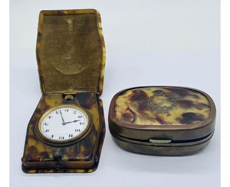 A tortoiseshell snuff box inlaid with brass along with a faux tortoiseshell travel clock