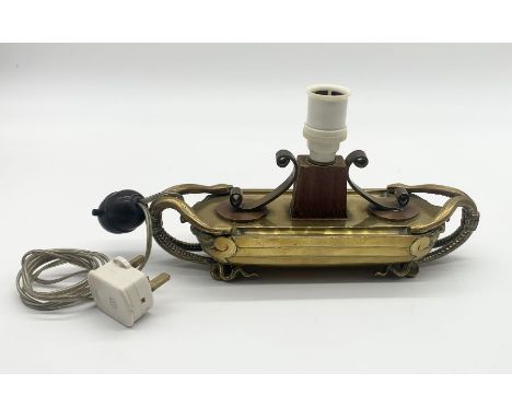 An Eastern brass lamp in the shape of a boat with snake formed handles 