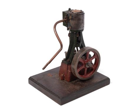 A Stuart Turner vertical stationary steam engine mounted on a wooden plinth. Height 22cm.  Engine turns as it should, unteste