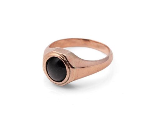A 9ct rose gold and cabochon set ring, the black oval stone likely jet, somewhat abraided, size R, 6.4g.
