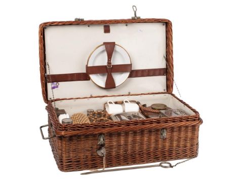 A quality early c20th Picnic set in a basket hamper containing ceramic cups &amp; saucers, bottles, sandwich tins and a spiri