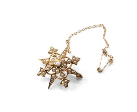A Victorian 15ct gold and seed pearl star burst brooch, 3.0cm, marked 15ct to the back, 5.2g with pin and safety chain.