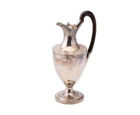 A George III Neo-Classical silver wine ewer of pedestal form, with anthemion finial to the hinged lid and ebony auricula hand