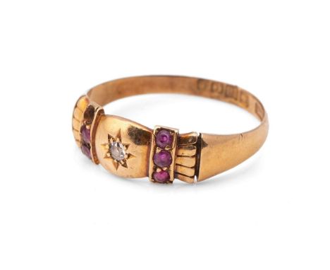 An 18ct gold, diamond and ruby ring, with central starburst set diamond, with a row of three rubies either side, size R 3.2g,