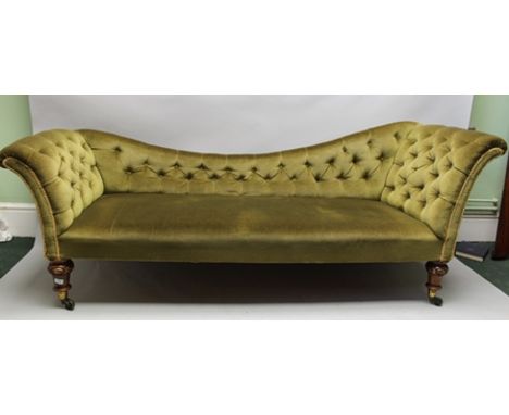 A VICTORIAN BUTTON BACK SOFA with scrolling ends, the one side higher, in the manner of a chaise longue, green fabric upholst