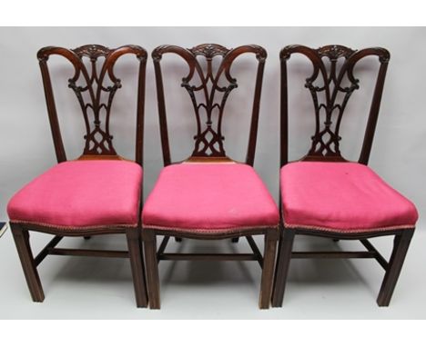 A SET OF SIX CHIPPENDALE DESIGN MAHOGANY SINGLE DINING CHAIRS, having pierced and carved splat backs, serpentine seats uphols