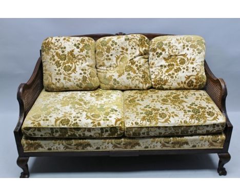 AN EDWARDIAN STAINED BEECH FRAMED THREE-PIECE BERGERE SUITE, comprising sofa and pair of armchairs, with loose cushions, havi