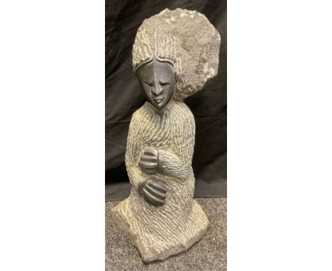 Tribal Art - a carved hardstone figure of an elder, standing with her hands grasping her dress, polished and textured finish,
