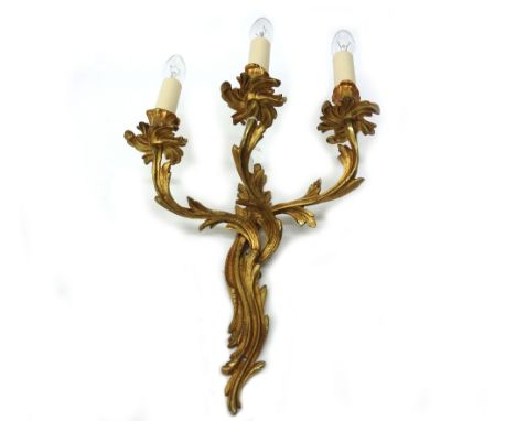 A set of four Louis XV style gilt metal three light wall applique, 20th century, cast with scrolling acanthus, 47cm high.
