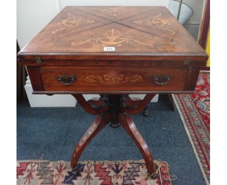 A late Victorian rosewood floral marquetry envelope top card table, boxwood strung, with a frieze drawer, with a turned lobed