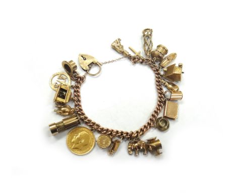 An early 20th century rose gold curb link bracelet, each link stamped '9' and '.375' and hung with nineteen mostly 9ct gold c
